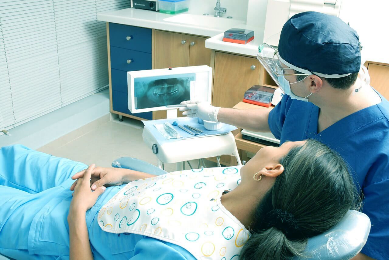 Doctor showing dental x-ray to patient